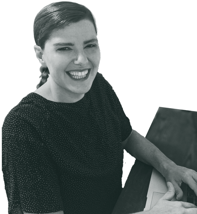 Bethany Fisher is shown sitting at her desk, smiling directly at the camera. The image is desaturated, with a green overlay that matches the site design